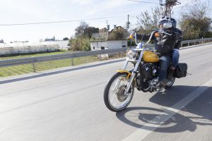 Antalya, Turkey - November 23, 2014: Happy bikers does the typical greeting riding Harley Davidson at motorcycle rally "Alanya Tour" by Antalya Chapter. Photo was taken at Antalya-Alanya Road in the Antalya in the Turkey. This guy Harley Owners Group Antalya Chapter member